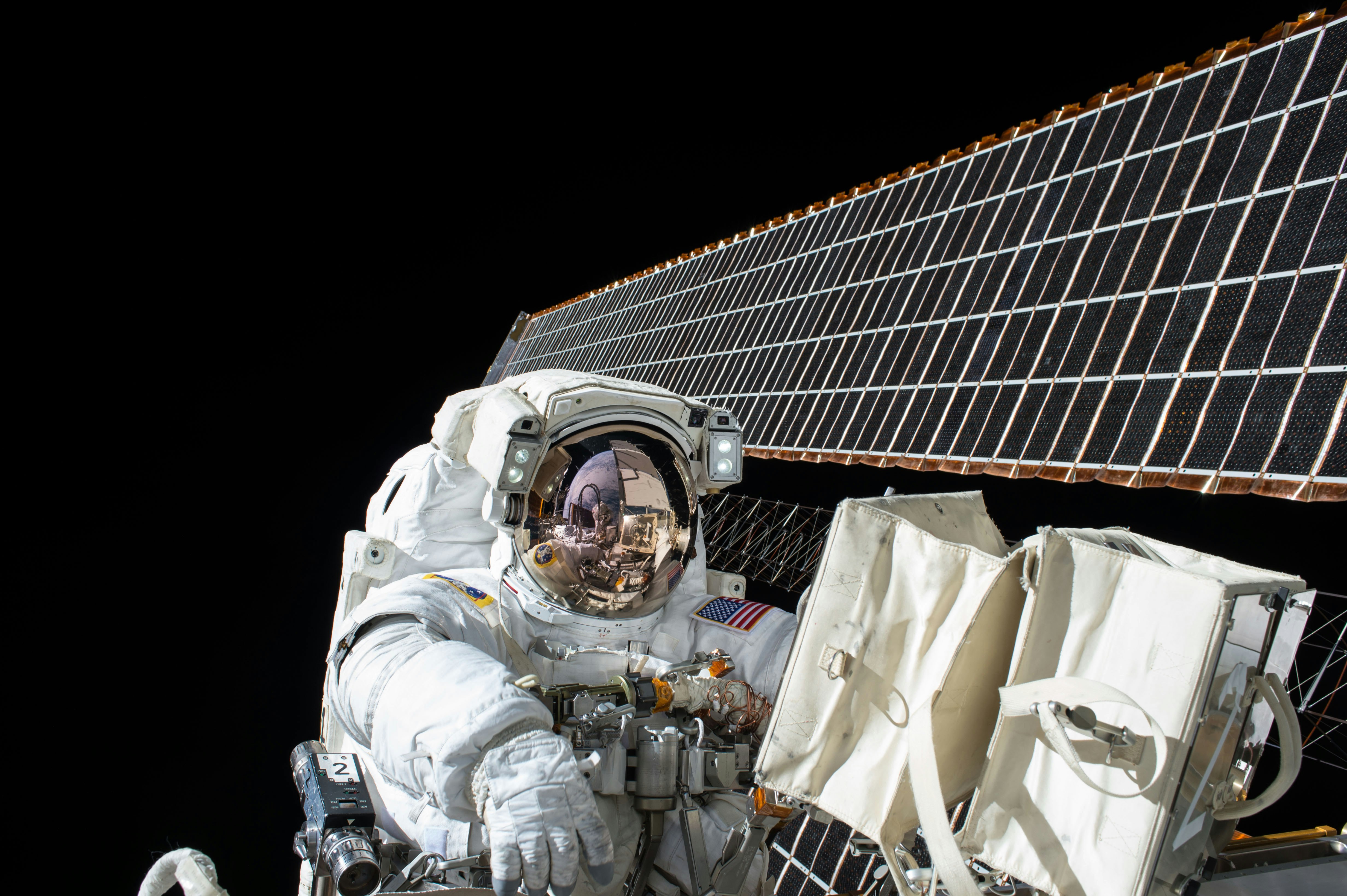 photography of Astronaut beside satellite